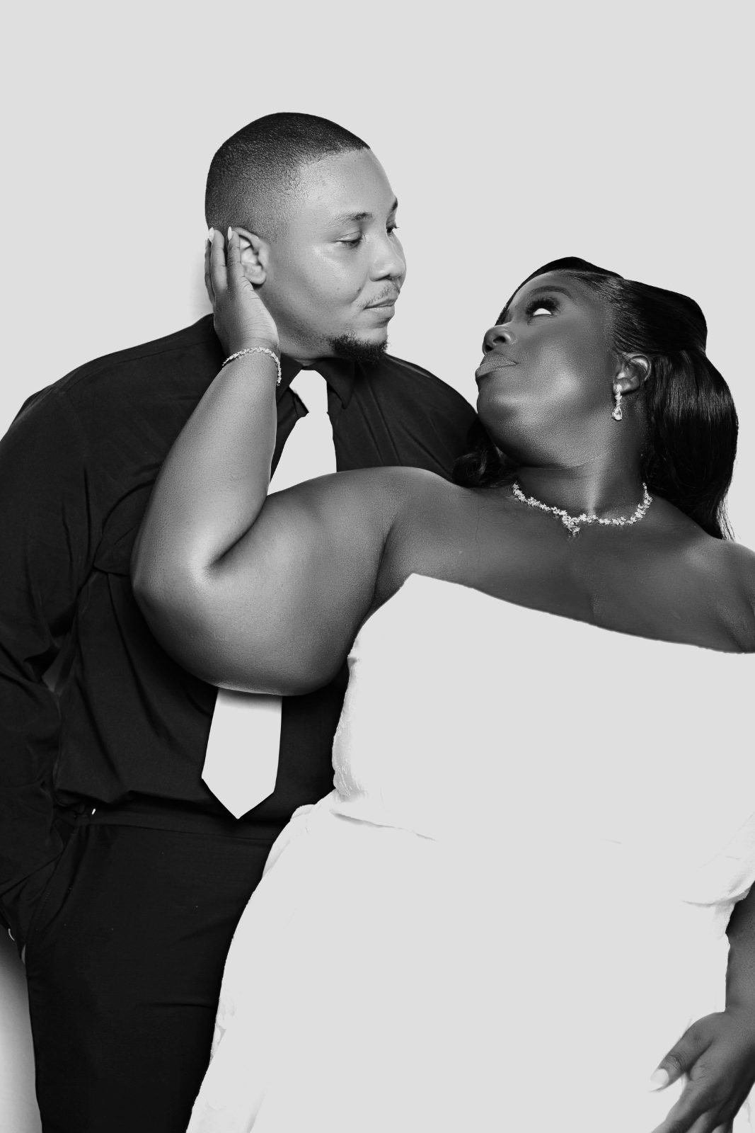 Couple posing in a black and white portrait photo booth