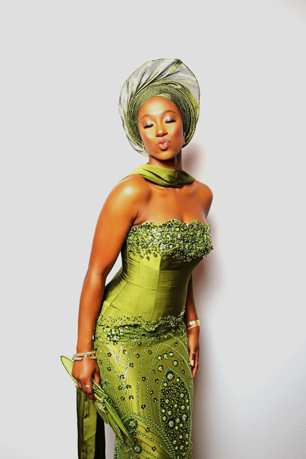 Wedding guest in green gele at the portrait photo booth